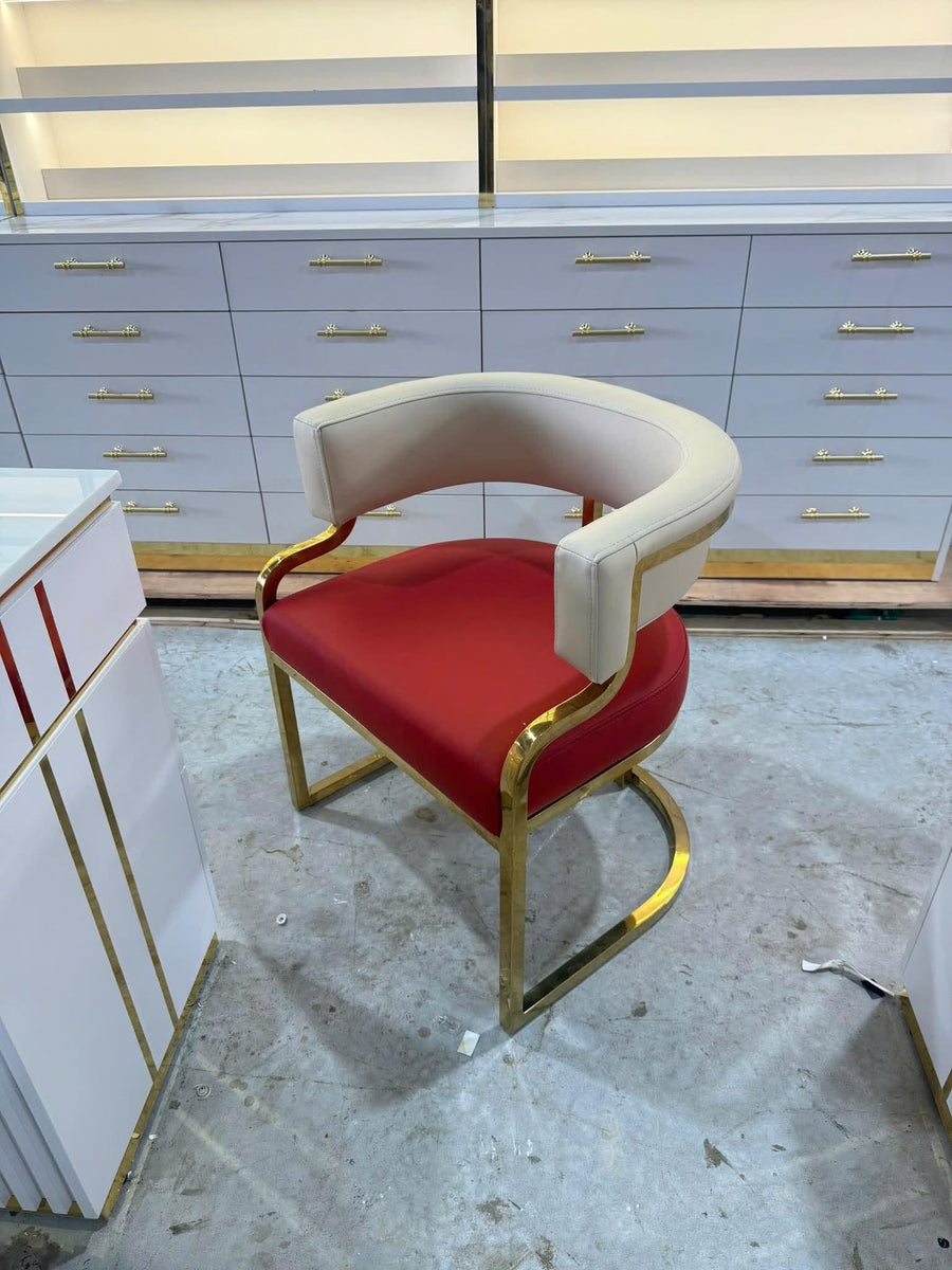Guest chair with a gold frame, red seat and cream backrest