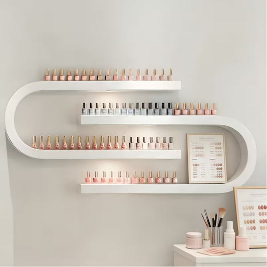 Cast iron U-shaped wall shelf holding nail polish bottles